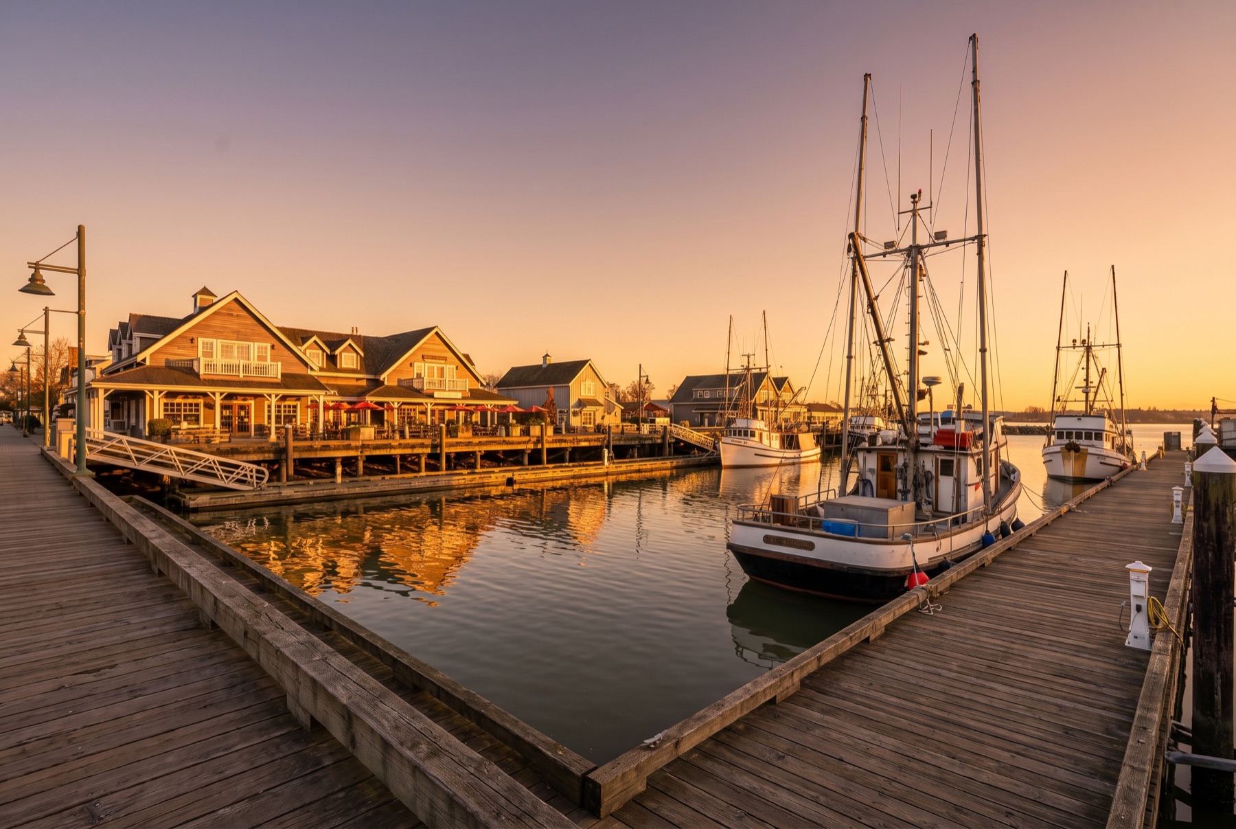 Steveston Village boardwalk and fishing boats at golden hour